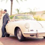 Newlyweds standing in front of car at Rosen Shingle Creek