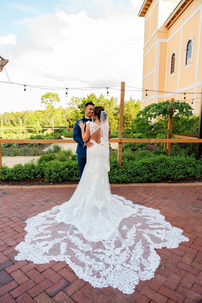 A bride and groom embrace at Rosen Shingle Creek, part of the Rosen Weddings family of venues and the perfect homebase for a winter getaway for couples.