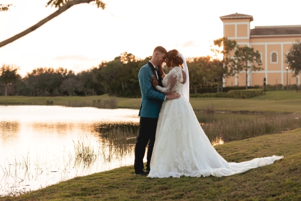 A bride and groom embrace during an autumn sunset at Rosen Shingle Creek, a wedding venue in Orlando.