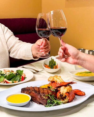 A couple sharing dinner and wine at Jack's Place Restaurant at Rosen Plaza, one of the best Orlando date ideas.