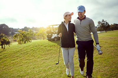 A couple walking on Rosen Shingle Creek Golf Course in Orlando, part of the Rosen Weddings family of romantic Orlando hotels.