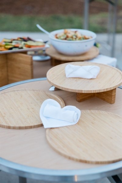A wedding dining table display with white napkins in the shape of a heart.