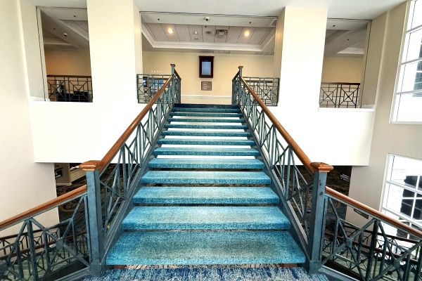 A view looking up to the landing at the top of the Grand Staircase at Rosen Plaza.