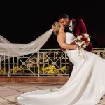 A Couple Pose for a Dramatic Nighttime Wedding Photo at Rosen Plaza on a Balcony