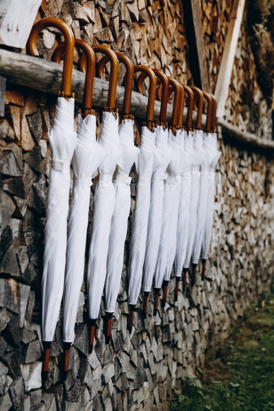 A hanging row of white umbrellas, perfect for a rainy day wedding.