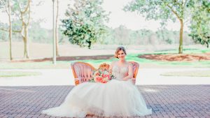 Bride Sitting On Couch with Flowers