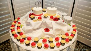 Red/Yellow Froseted Cupcakes and Cake on Table