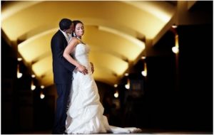 Groom Holding Bride in Hallway for Photoshoot