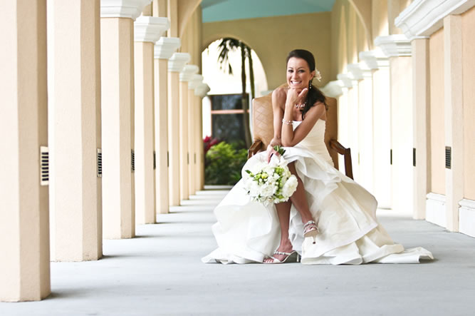 Bride Sitting Down Posing with Flowers