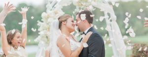 Newlyweds Surrouned by Flowers Thrown from Wedding Party