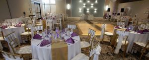 White, purple, and gold table setup