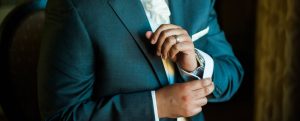 Up close picture of groom buttoning sleeve