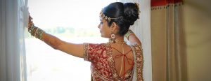 Bride in Tradition Indian Wedding Dress Looking out Window